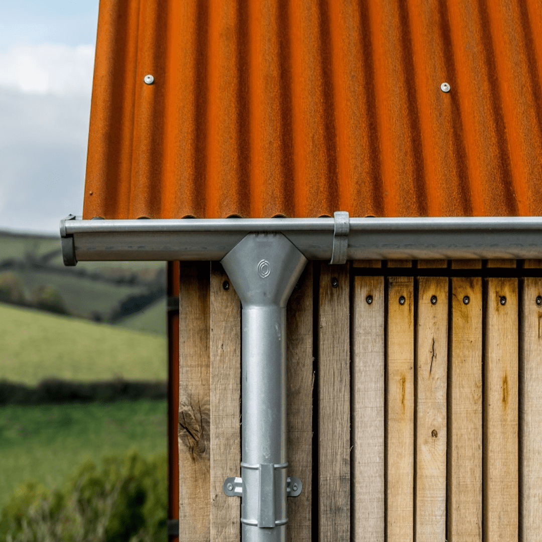 Corten roof, lindab galvinised rainwater guttering. vertical larch cladding
