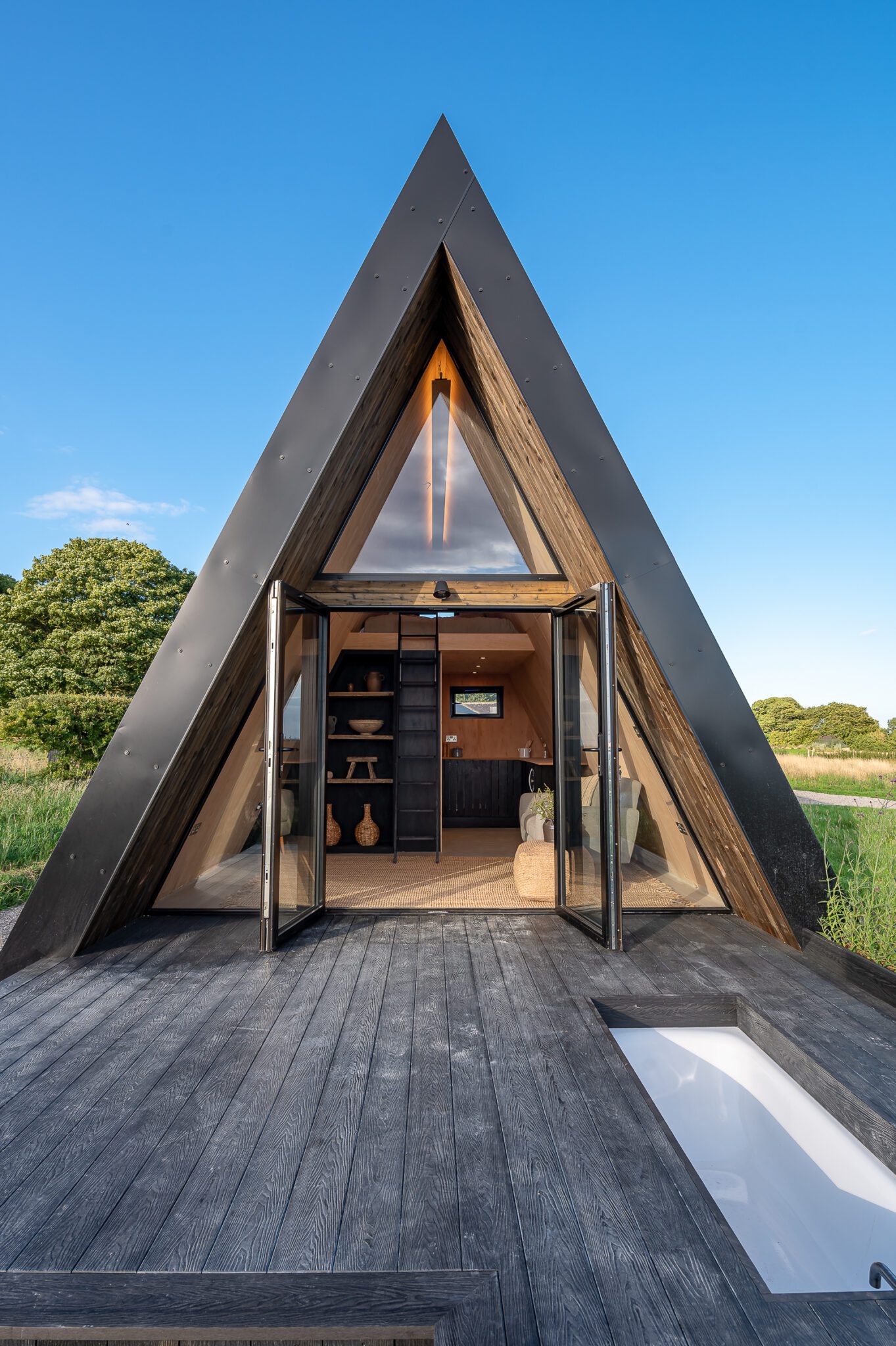 A Frame Cabin design with black large south face glazing _ Life Space Cabins