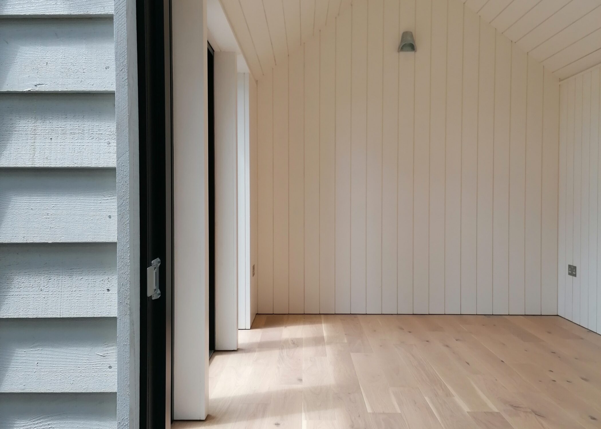Tamar Cabin. A summerhouse cabin with engineered oak flooring and painted Farrow and Ball Wimborne White timber t&g cladding _Life Space Cabins.jpg